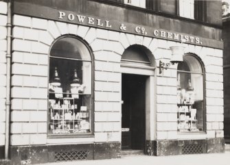 Edinburgh, 23 Bernard Street.
View of shop front of no.23 with lettering, Chemist's insignia and gratings under window.