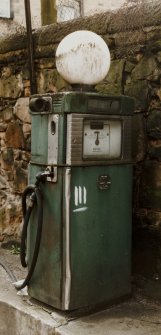 Detailed view of a red petrol pump to the rear of the C&J Brown's warehouse.