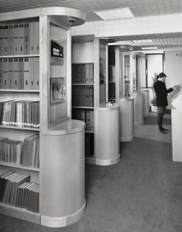 Interior view of the Monuments Record library seen from the North with Jane Thomas.