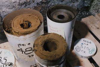 View of decaying vertical aerial negatives in film cans.
