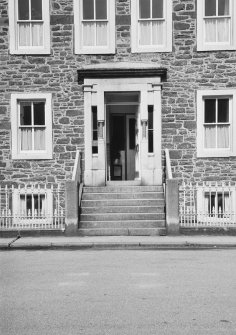 Detail of SE elevation showing main entrance, centre bay windows and iron railings.