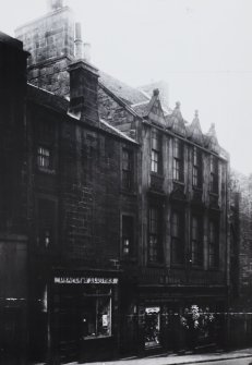 View of 261-267 Canongate, showing draper, pawnbroker, boot shop and florist