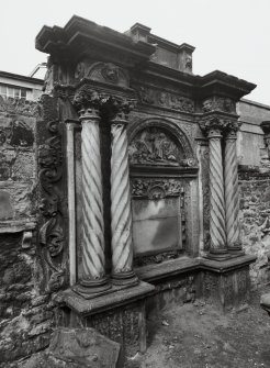 View of funerary monument on west wall of churchyard.