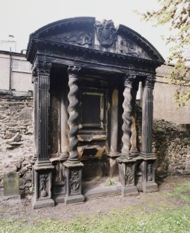 View of funerary monument on West wall of churchyard