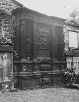 Detail of monument in wall of churchyard.