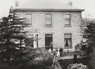 Historic photographic view of S elevation with figures standing at entrance.
Insc: 'no. 2, Hillside House, Duddingston, April 1909, J B W'.