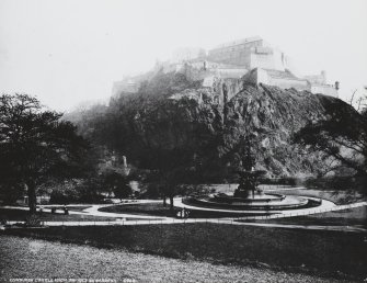 General view of Edinburgh Castle with Princes Street Gardens and Ross Fountain in foreground, inscr; 'Edinburgh Castle from Princes St. Gardens.', written on historic print mount is a poem, 'Here wealth still swells the Golden tide...'