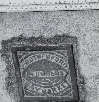 Tap cover inscribed J Rutherford Plumbers, Haymarket
