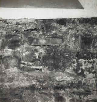Interior-detail of blocked opening below East window in South wall.