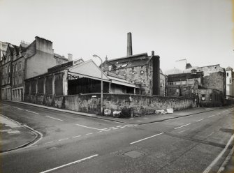 General view of Brewery from North East, showing tenement block at 18-24 Guthrie Street, open-fronted Cask Shed, central block containing Tun Room and Brew House, and Cooperage