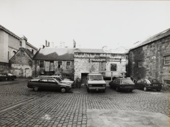 View from South South East of block containing Barley Bins and Mill Room, Old Kiln and Tailors' Hall which contained the Brewery's Sample Room, and the South end of the West wing containing the Stables