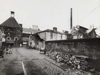 General view from East of one of two Kilns at end of former Maltings range converted to University of Edinburgh's Architecture Department, block containing Barley Bins amd Mill Room, and part of Brew House