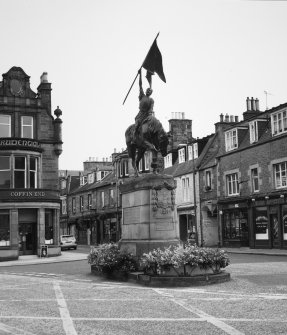 View of statue commemorating the return of Hawick callants from Holnshole in 1514 by W F Beattie (1914) from WSW