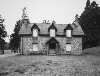General view of lodge, with the windows boarded up.