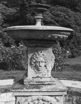 East fountain, relief mask on square stem underneath circular basin, detail