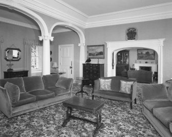 Interior.
View of first floor drawing room from W showing the ionic arcade and archway to the library.