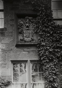 Detail of heraldic stone in wall of farmhouse.
