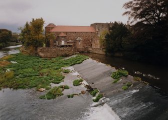General view of Gimmers Mill from SSW, with weir in foreground.