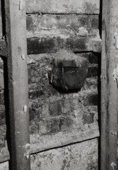 Interior.
Detail of first floor S wall showing sawn off beam end.