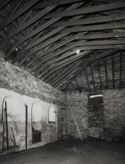 Interior view from SE within stables, showing alcoves (left).