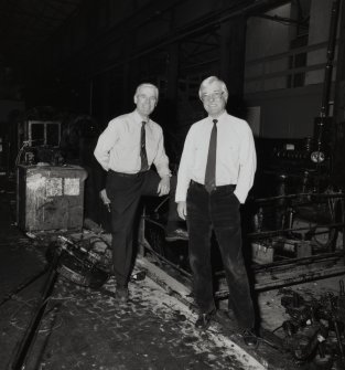 Interior.
View of Duncan Tait (left) and Andrew Smith (right), in front of Closing Machine (L1).