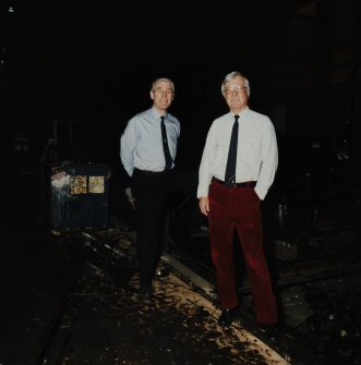 Interior.
View of Duncan Tait (left) and Andrew Smith (right), in front of Closing Machine (L1).