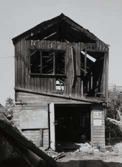 View of two storey wooden shed (to rear) from S.