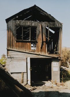 View of two storey wooden shed (to rear) from S.