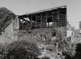 View of two storey wooden shed (to rear) from W.