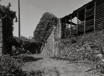 View of Two storey wooden shed (to rear) from S.