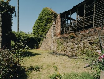 View of two storey wooden shed (to rear) from SW.