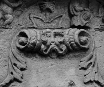 Detail of carved head on funerary monument.