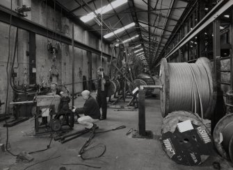 Interior.
View of ropery from E of stock rope racks, with three members of staff salvaging plant for sale, following closure.