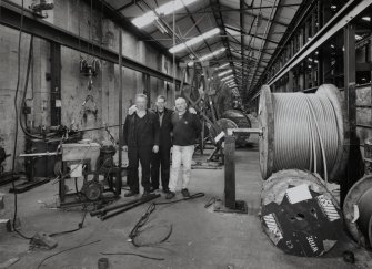 Interior.
View of ropery from E of stock rope racks, with three members of staff preparing plant for post-closure sale.