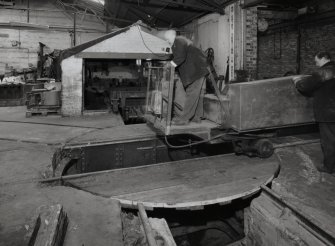 Interior.
View of ropery, 100-ton Test Range from W of winch house, with bogie turntable in foreground, and winch end of neighbouring 500-ton test range just visible to right. This view shows bogie being maneouvred onto turntable.