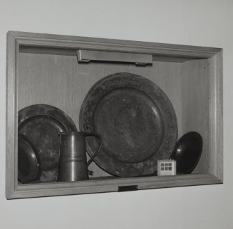 Interior
South wall, cabinet, pewter plates and tankard, detail