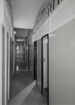 Interior. 1st floor, view along corridor between wooden cubicles, with fireproof vaulting visible