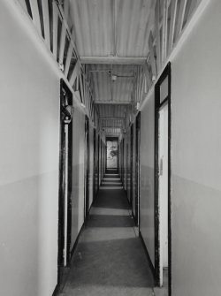 Interior. 3rd floor, view from W along corridor between cubicles, showing upper floor structure of corrugated-iron vaults supported on cast-iron beams