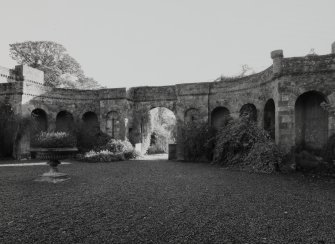 View of arcade flanking the entrance arch from W