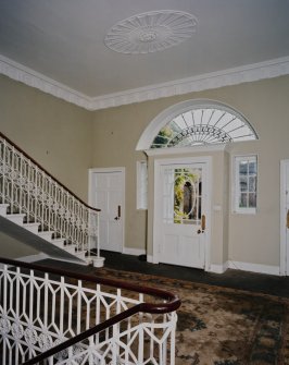 Interior. Ground floor View of entrance hall from NW showing staircase and front door