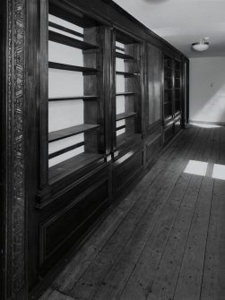 Interior. 
First floor North corridor, detail of bookshelves constructed from woodwork from SS Columbia in 1934.