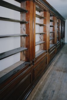 Interior. 
First floor West corridor, detail of bookshelves constructed from woodwork from SS Columbia in 1934.