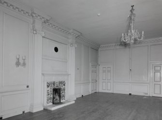 Interior. 
First floor drawing room, view from S showing the late 18th century chimney piece flanked by Ionic pilasters.