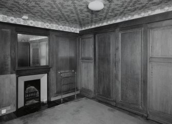 Interior.
First floor panelled bathroom, view from N with bath door panels closed.