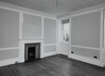 Interior. 
Second floor West bedroom, view from East showing panelling and fireplace.