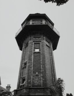 View looking up to tower from West, showing 1879 date plaque