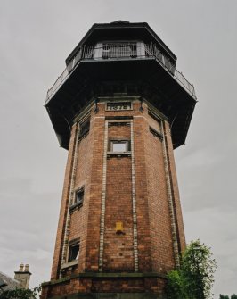 View looking up to tower from West, showing 1879 date plaque