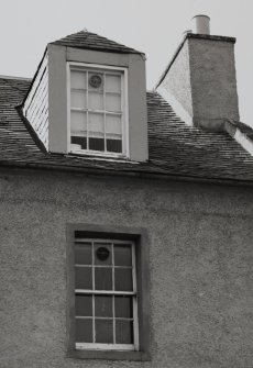 Detail of chimney, dormer window and top floor window.