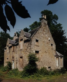 View from SW showing blocked opening in the W gable of the 17th century house and 19th century addition.