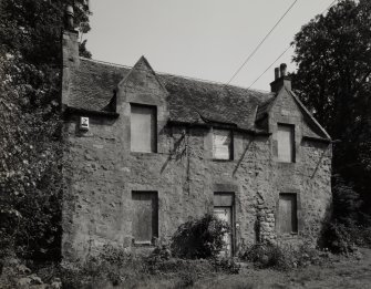 View from W showing blocked 17th century windows in gable and 19th century W facade.